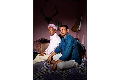 Members of Dom Raja Om Chaudhry’s family sit in their home