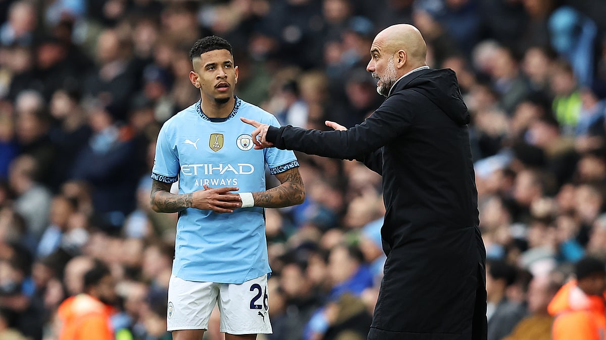 Manchester City's Savinho and Pep Guardiola