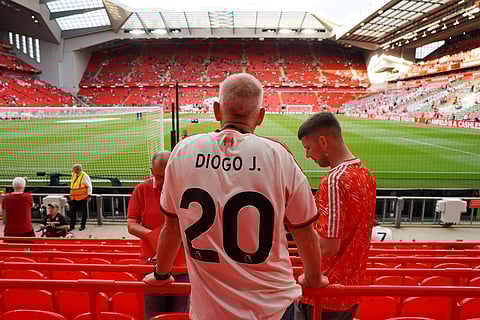A supporter wearing the late Liverpool player Diogo Jota's jersey