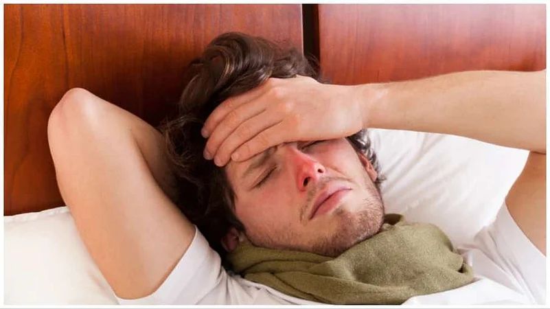 A sick man with his hand on his forehead