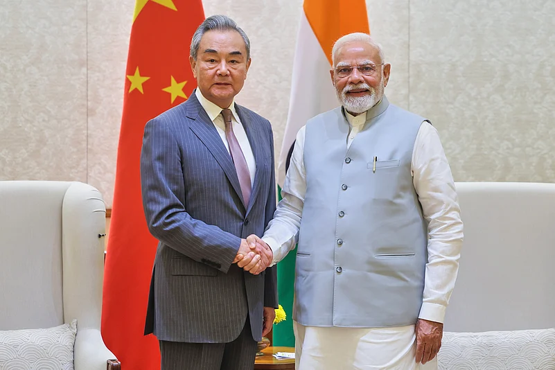 ndian Prime Minister Narendra Modi, right, shakes hand with Chinese Foreign Minister Wang Yi