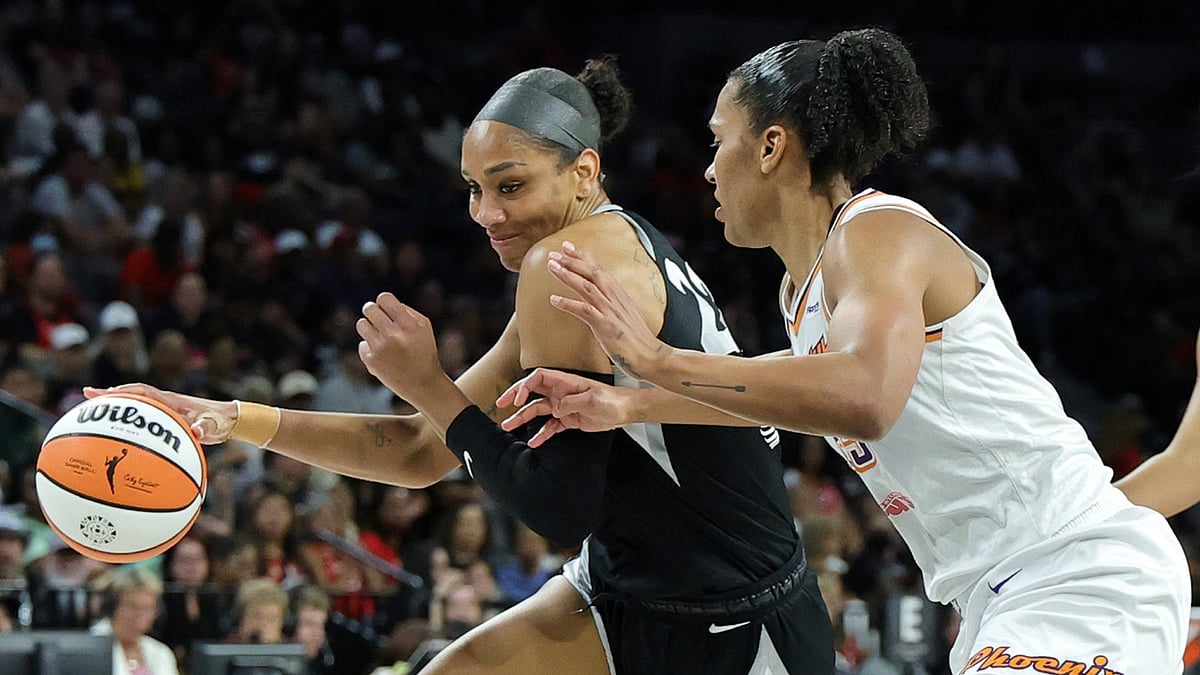 A'ja Wilson #22 of the Las Vegas Aces drives against Alyssa Thomas #25 of the Phoenix Mercury in the third quarter of their game at Michelob ULTRA Arena on August 21, 2025 in Las Vegas, Nevada. The Aces defeated the Mercury 83-61.