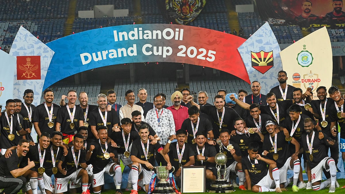 PTI : NorthEast United FC's players pose with the trophy after winning the Durand Cup 2025 in Kolkata.