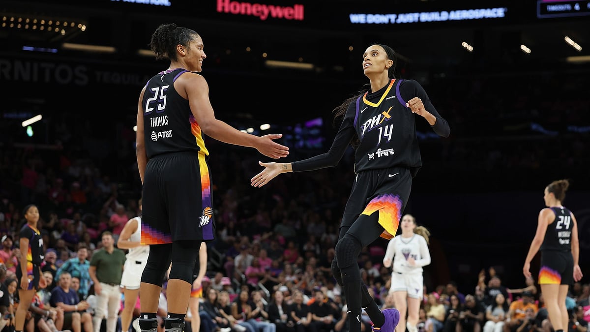 DeWanna Bonner #14 of the Phoenix Mercury high fives Alyssa Thomas #25 after a three-point shot against the Golden State Valkyries during the second half of the WNBA game at PHX Arena on August 22, 2025 in Phoenix, Arizona.