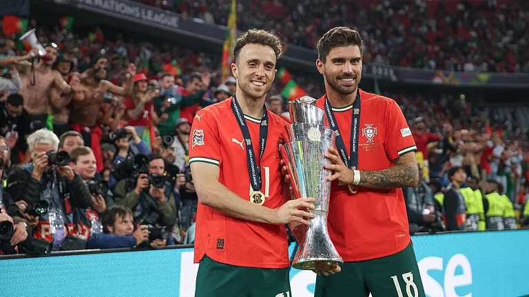 Diogo Jota and Ruben Neves hold the Nations League trophy after Portugal's victory in June - null