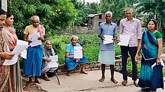 | Getty Images : The Countdown - Villagers hold up enumeration forms distributed in Bihar during the Special Intensive Revision of 
electoral rolls