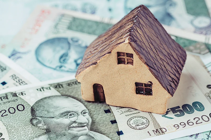 House model placed on Indian currency, symbolizing housing demand in India