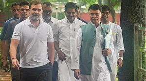 Outlook : Congress leader Pawan Khera with Rahul Gandhi (L).