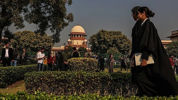 Getty | : Lawyers walks by the Supreme Court building in their robes |