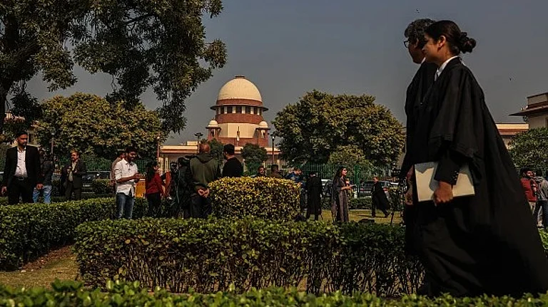 Lawyers walks by the Supreme Court building in their robes | - Getty |