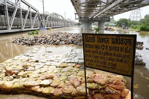 Swelled and stagnant Yamuna water below the old iron brigde. 