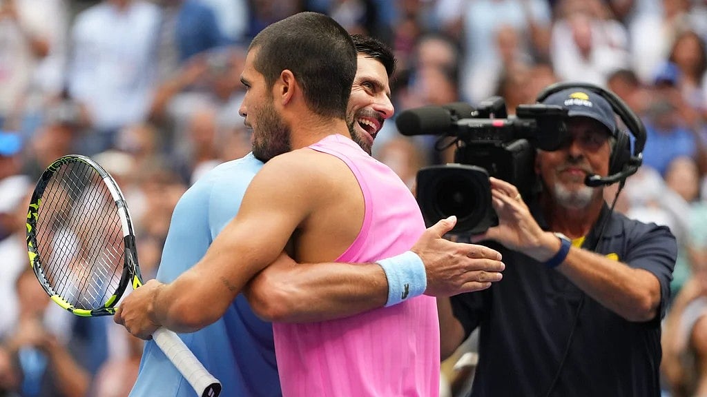 Novak Djokovic, of Serbia, hugs Carlos Alcaraz, of Spain, after losing 