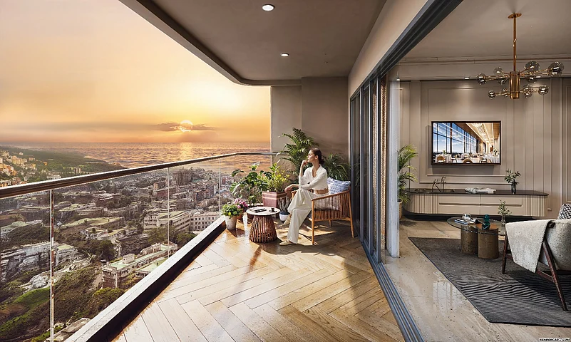 A girl is sitting on a chair in a big balcony and enjoying the view