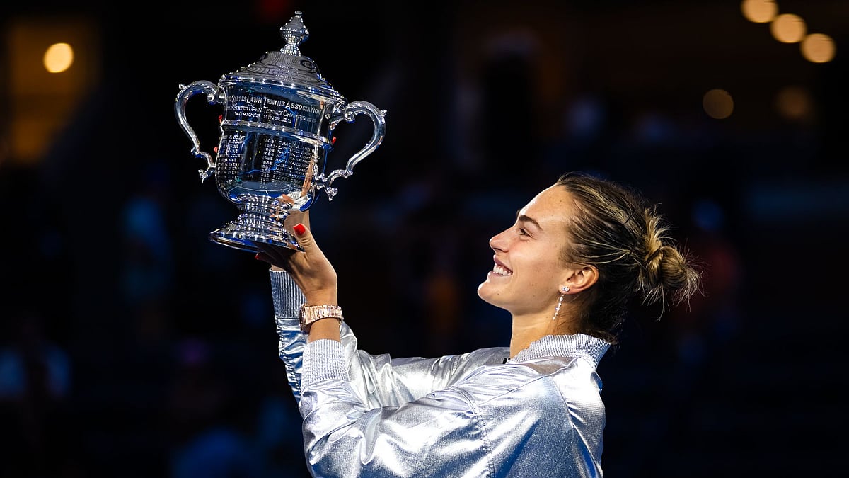 Sabalenka holds the trophy high in New York