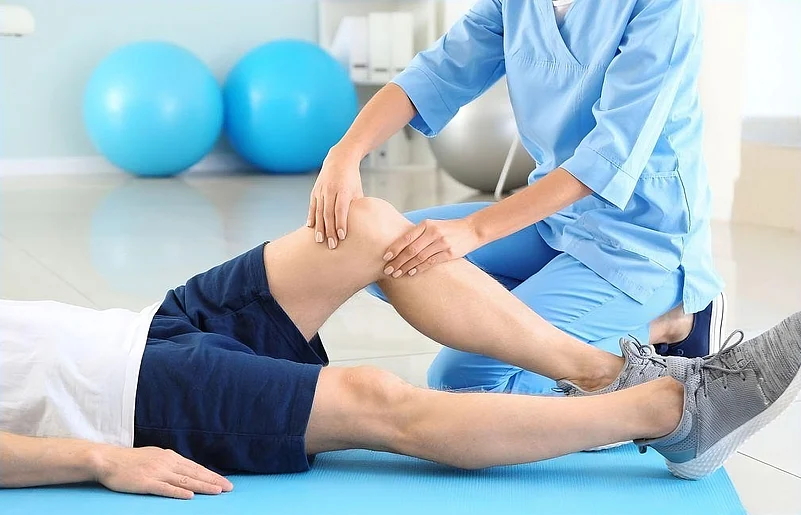 A medical professional providing physiotherapy to a man
