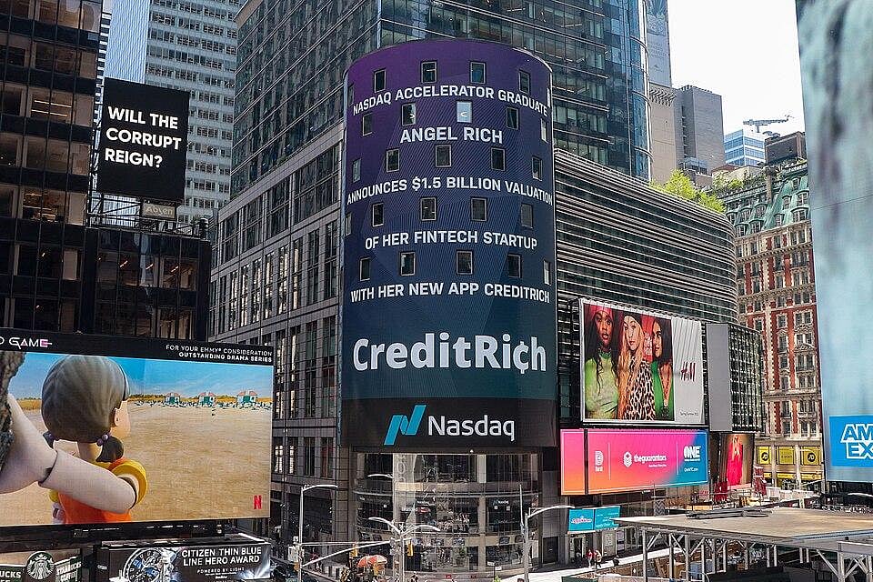 A photo of Times Square with billboards, one of which displays a Nasdaq ad for CreditRich