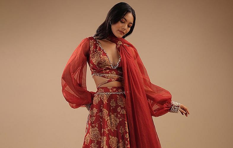 A woman in red floral lehenga.