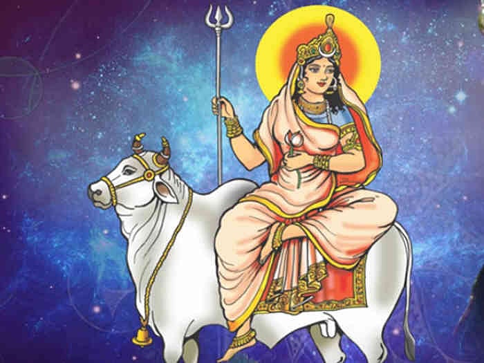 Goddess Shailputri riding a white bull (Nandi) with a trident, against a celestial blue background.