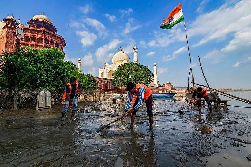 Cleaning work after recession of Yamuna water
