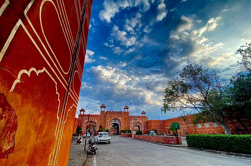 A breathtaking glimpse of Jaipurs iconic Ajmeri Gate under a dramatic morning sky.