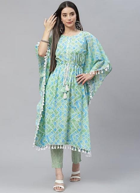 A woman wearing a blue, printed kaftan kurti, posing on a light background.