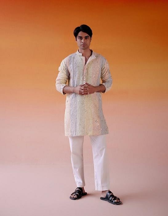 A man in a white kurta and pajama.