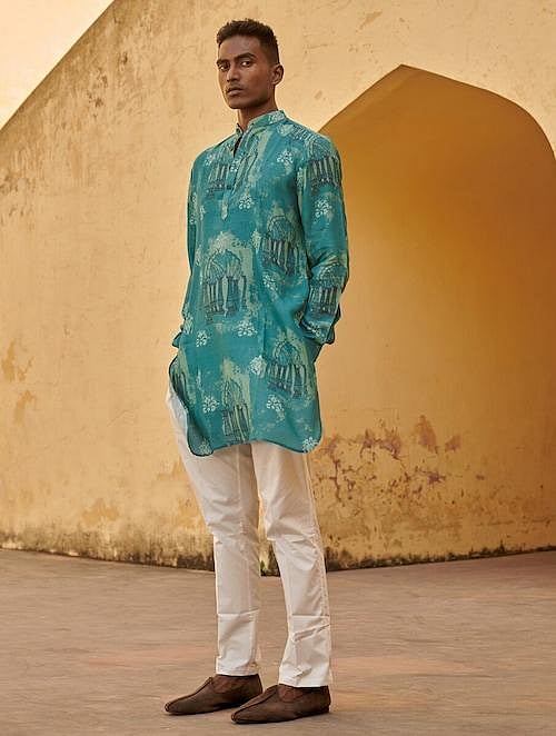 A man in blue printed kurta and white pants.