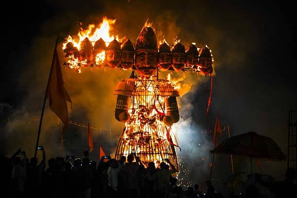 A large Ravan burns brightly at night during the Dussehra festival