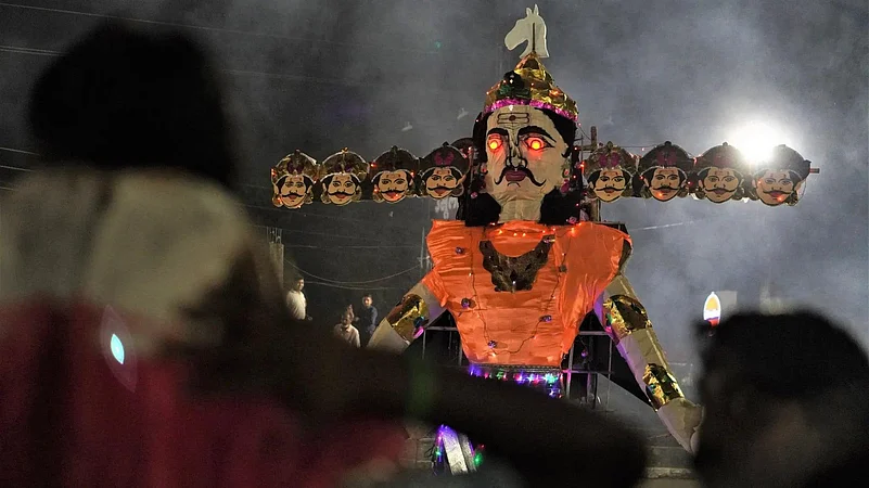 A multi-headed effigy of ravana with glowing eyes, lit up at night