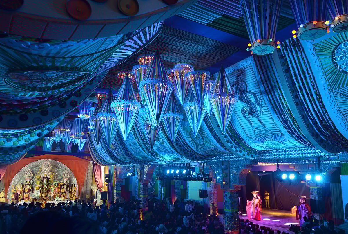 Durga Puja pandal at night, illuminated with blue lights.
