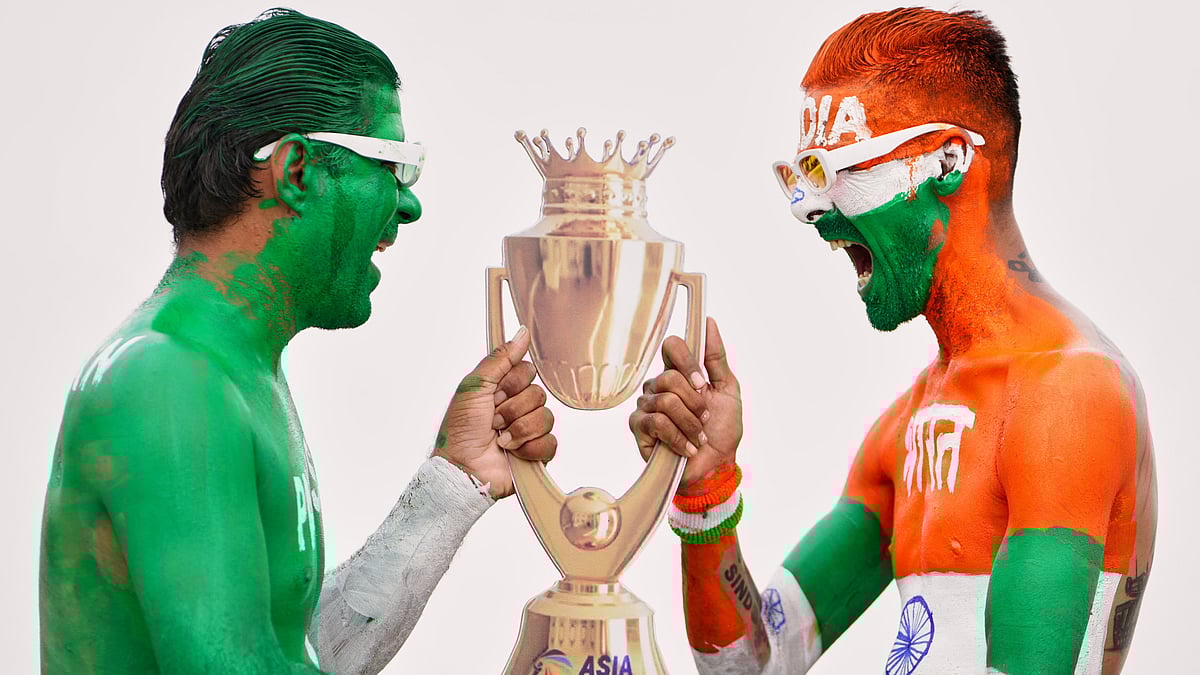 Indian cricket fans, with their bodies painted in the colors of Indian and Pakistan flags, pose for the media with a cutout image of the Asia Cup trophy in Ahmedabad, India, Saturday, Sept. 13, 2025, the eve of the Asia Cup match between the two countries. - | Photo: AP/Ajit Solanki