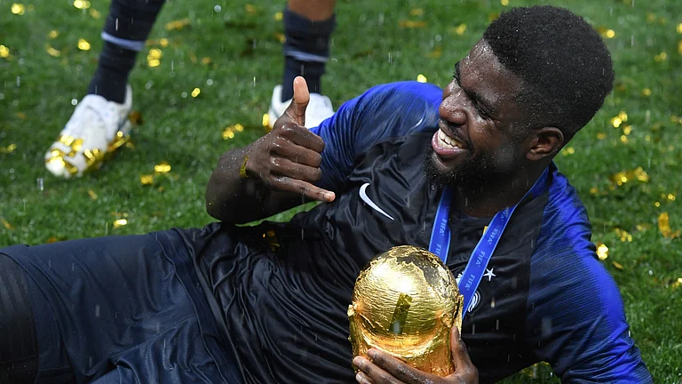 Samuel Umtiti poses with the World Cup trophy - null