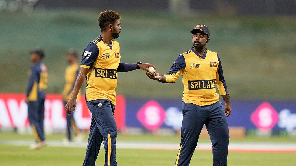 AP/Altaf Qadri : Sri Lanka's captain Charith Asalanka, right, hand the ball to teammate Nuwan Thushara during the Asia Cup
