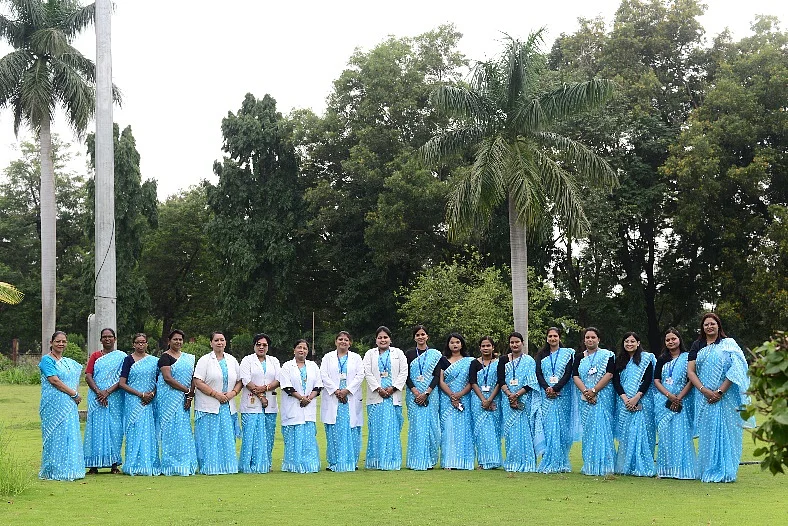HCL women employees wearing their new uniform and standing for a photo