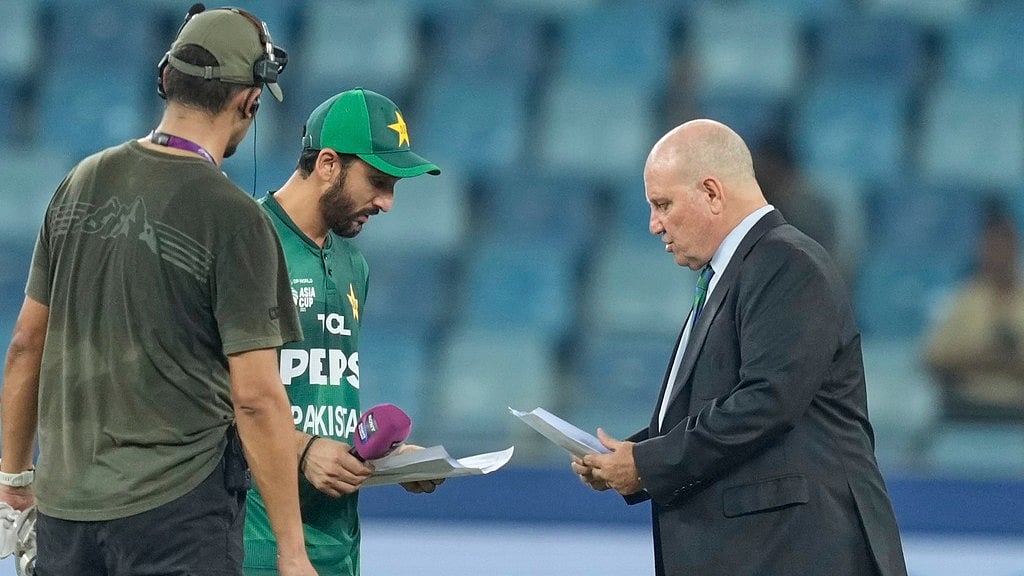 AP : Pakistan's captain Salman Agha shares team list with match referee Andy Pycroft at the toss before the Asia Cup 2025 match against UAE.