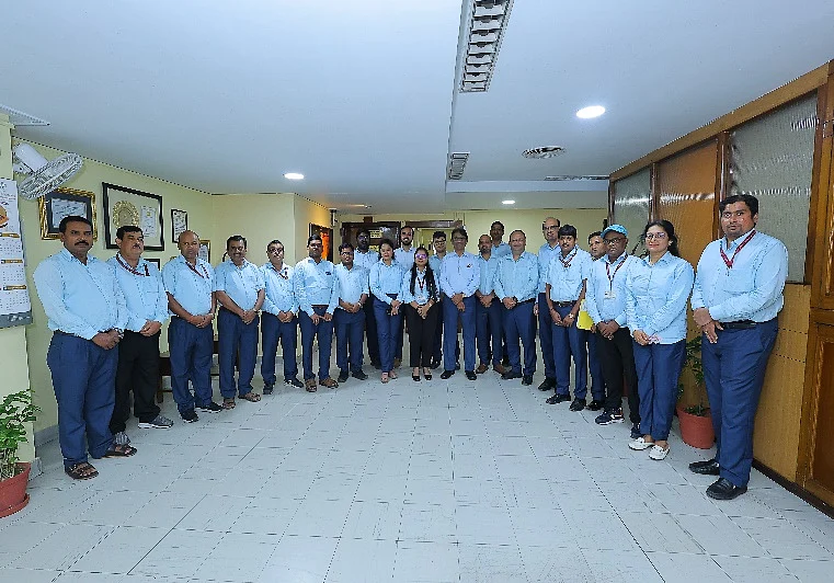 HCL employees wearing the new uniform and standing for a photo