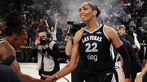 Chelsea Gray #12 and A'ja Wilson #22 of the Las Vegas Aces celebrate a 74-73 victory against the Seattle Storm in Game Three of the 2025 WNBA Playoffs first round at Michelob ULTRA Arena on September 18, 2025 in Las Vegas, Nevada.