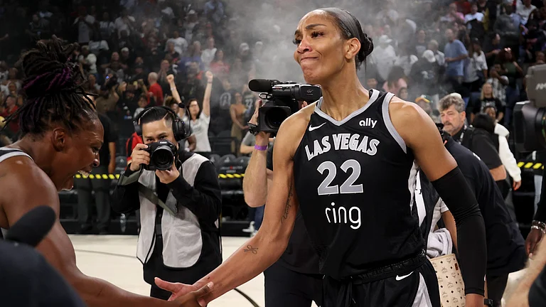 Chelsea Gray #12 and A'ja Wilson #22 of the Las Vegas Aces celebrate a 74-73 victory against the Seattle Storm in Game Three of the 2025 WNBA Playoffs first round at Michelob ULTRA Arena on September 18, 2025 in Las Vegas, Nevada. - null