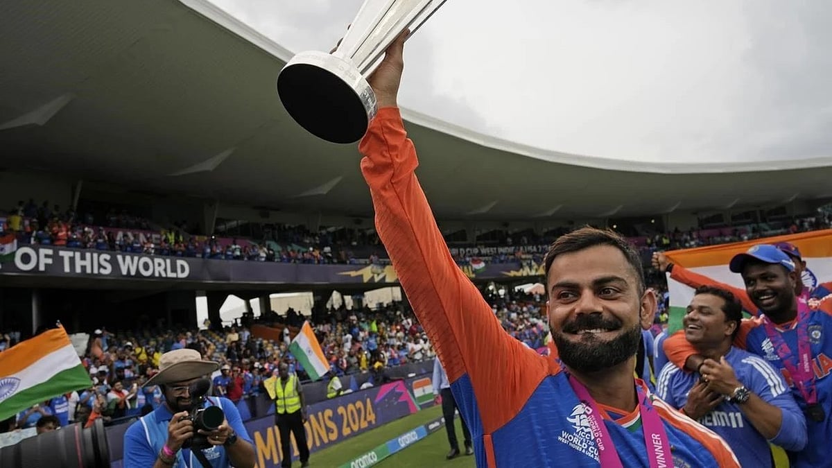 | Photo: AP/Ramon Espinosa : India’s Virat Kohli carries the winners’ trophy as he celebrates after India won the ICC Men’s T20 World Cup final cricket match against South Africa at Kensington Oval in Bridgetown, Barbados, Saturday, June 29, 2024.