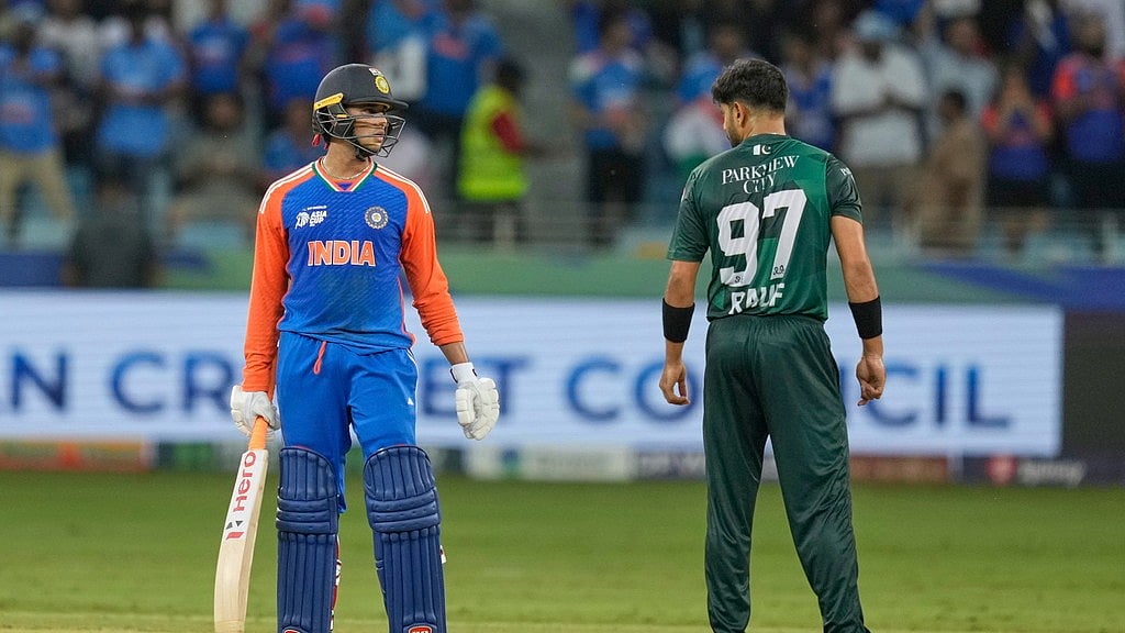 Indias Abhishek Sharma talks to Pakistans Haris Rauf during the Asia Cup 2025