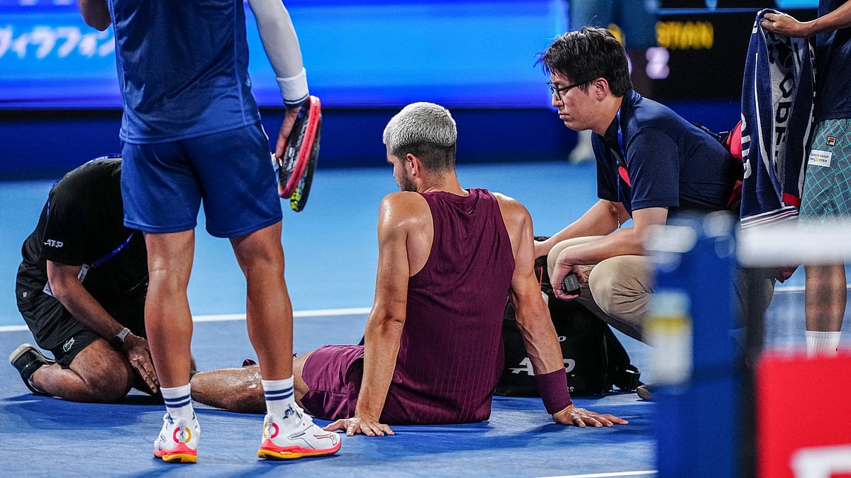 Carlos Alcaraz receives treatment on his left foot.
