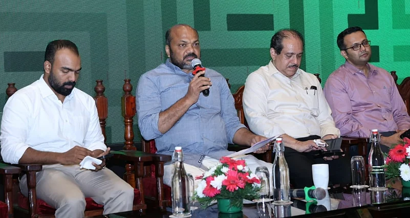 Minister Shri P Rajeeve speaking into a mic at the event