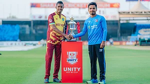 | Photo: X/CricketNep : West Indies captain Akeal Hosein and Nepal captain Rohit Paudel with the bilateral series tropy ahead of the first T20I match on September 27.