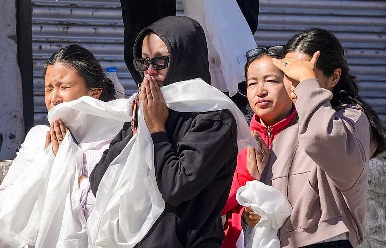 People pay their respects to 24-year-old Stanzin Namgyal, who was killed in violence during recent protests for Ladakh statehood, as his mortal remains are being taken for last rites amid curfew, in Leh, Sunday, Sept. 28, 2025. - S Irfan