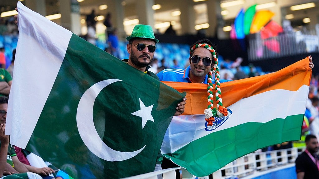 AP/Altaf Qadri : India's and Pakistan's fans carry their national flags as they wait for the Asia Cup cricket final between India and Pakistan to begin at Dubai International Cricket Stadium, United Arab Emirates