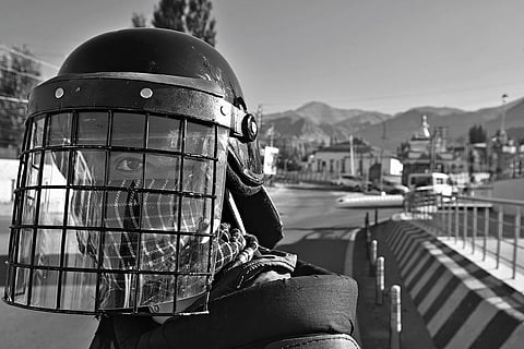 Riot police personal stand guard at the public square in Leh