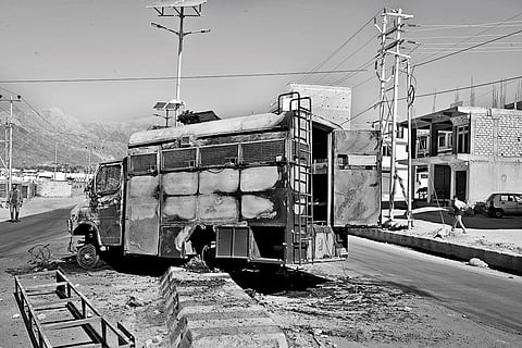 Charred remains of a police vehicle outside the BJP office in Leh