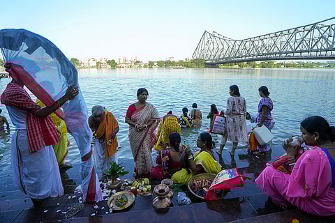 Maha Saptami rituals on Ganga River bank in Kolkata