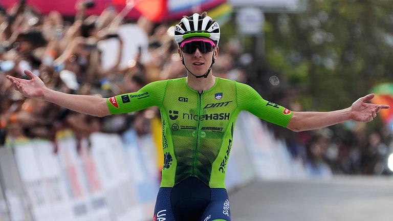 Slovenia's Tadej Pogacar celebrates winning the men's Elite road race, at the road cycling World Championships in Kigali, Rwanda, Sunday, Sept. 28, 2025 - AP/Jerome Delay