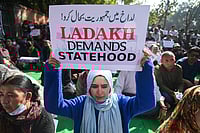 IMAGO / ZUMA Press Wire : A protestor holds a placard in a protest demanding statehood and other democratic rights for the Ladakh region in the Himalayas, in New Delhi. The Ladakh region was a part of the former state of Jammu and Kashmir, it was divided and made into a Union Territory in 2019 by the Indian Government.
